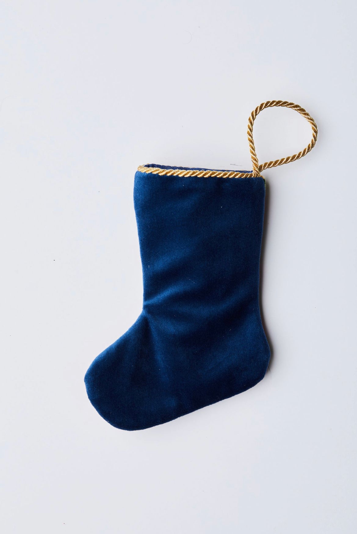 Back view of All I Want For Christmas 2023 needlepoint stocking with solid navy blue velvet backing