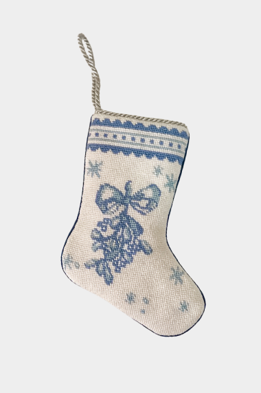 Needlepoint stocking featuring a blue mistletoe tied with a bow on a decorative border with snowflakes