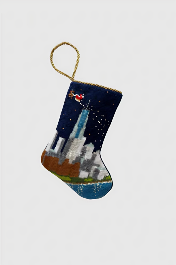 Needlepoint Christmas stocking featuring New York skyline and Santa sleigh under starry holiday sky