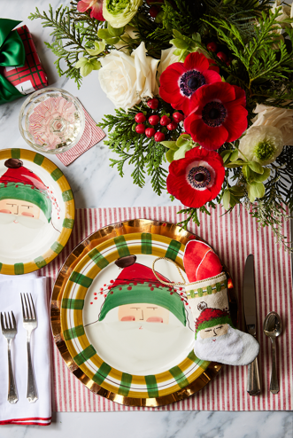 Santa-themed table setting styled with Bauble Stockings, holiday greenery, and red ornaments