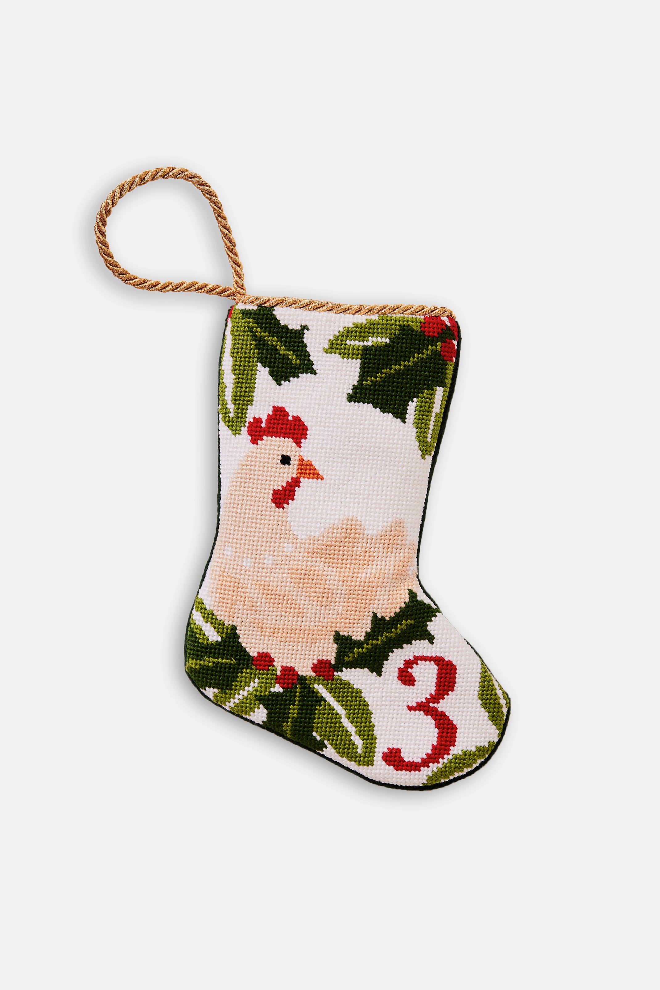 Needlepoint stocking featuring a hen with green holly accents on white backdrop