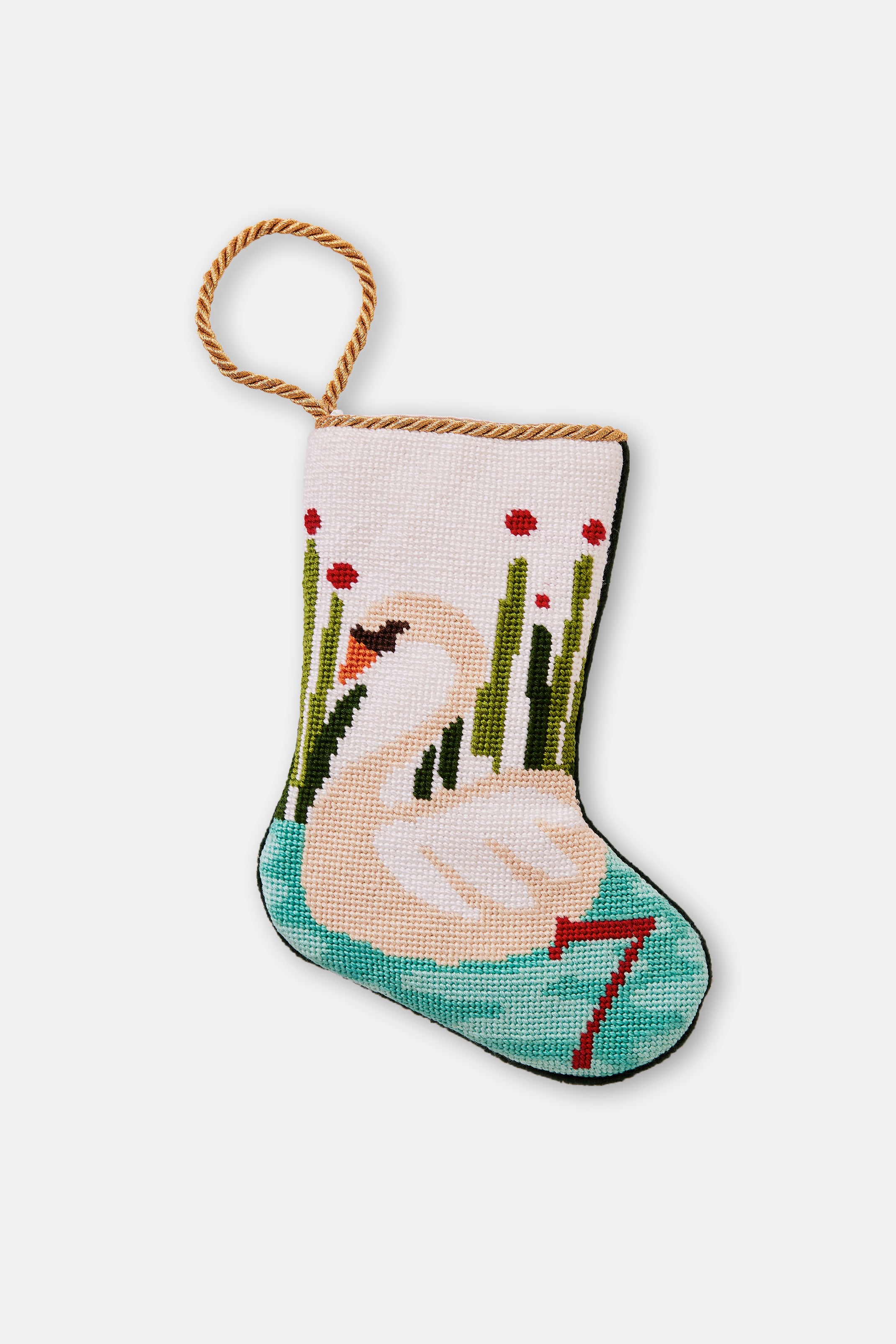 Hand-stitched stocking featuring an elegant swan swimming in the freshwater lake with cattails on a white backdrop