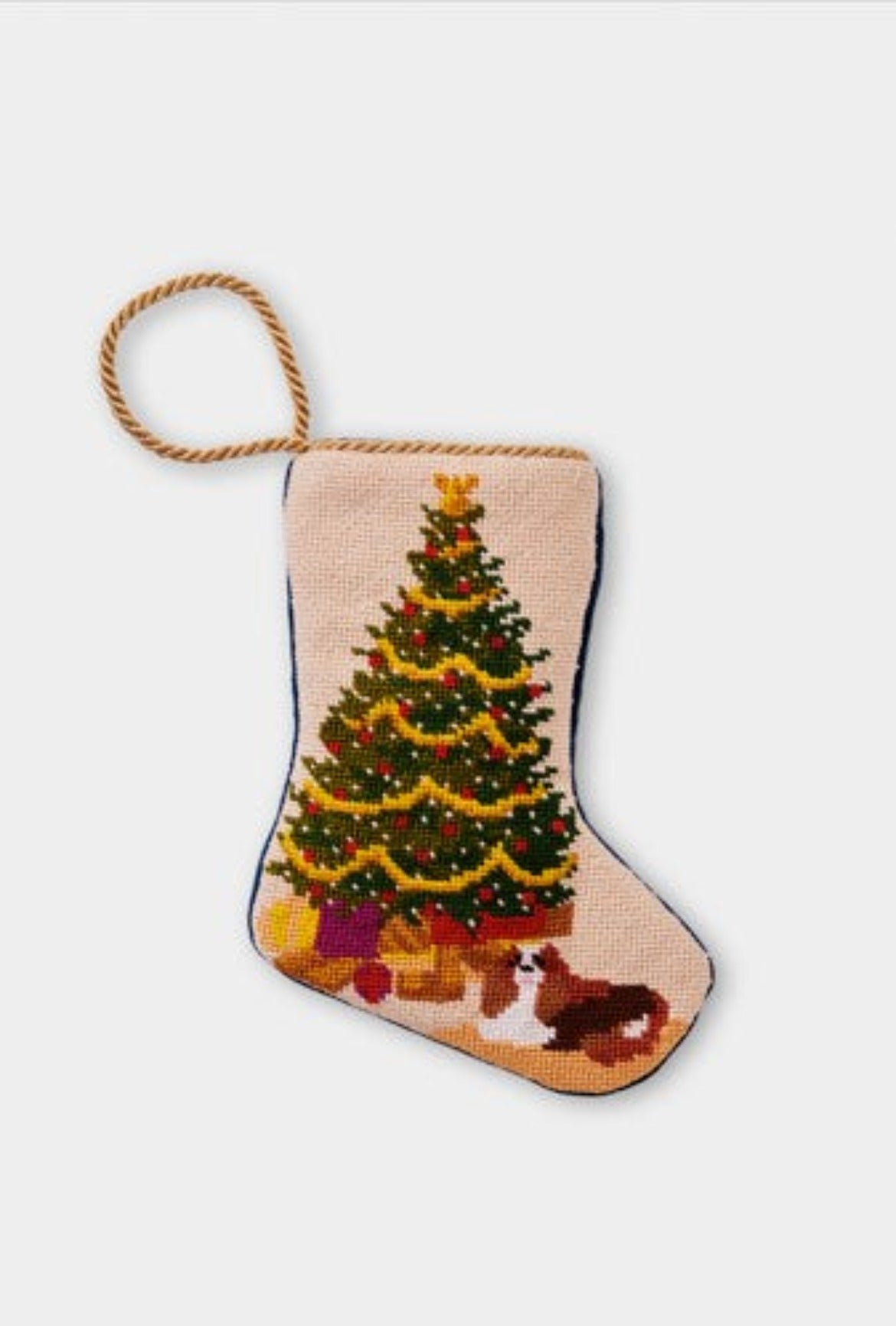 Needlepoint Bauble Stockings featuring a decorated Christmas tree with festive gifts and a dog sitting at the tree