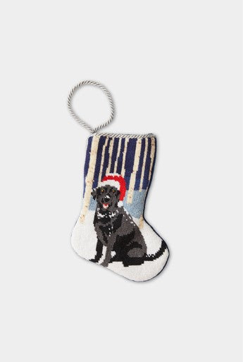 Hand-stitched stocking with black dog in Santa hat against frosty-themed background
