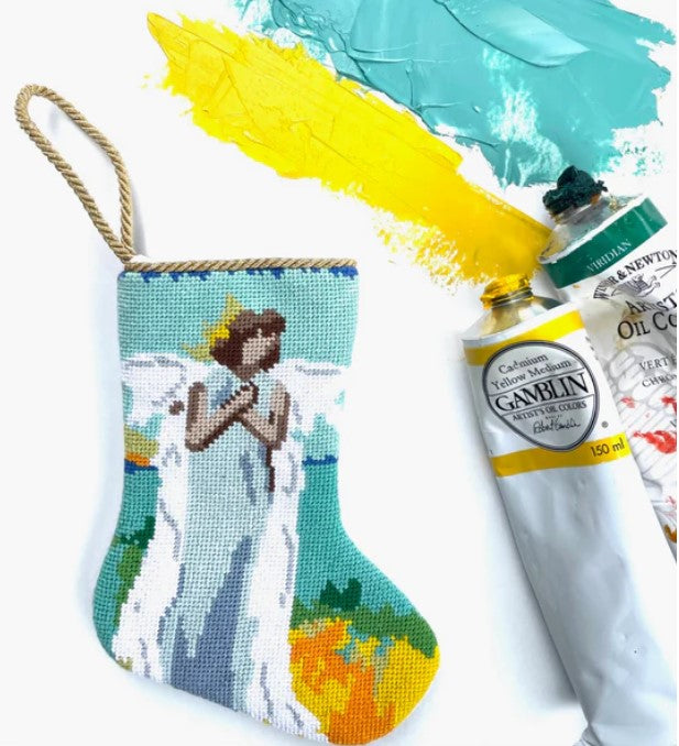 An image of Anne Neilson's painted-looking Bauble Stocking of an angel using blues, greens, and white