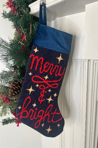 Full-size Christmas stocking featuring the Merry & Bright in bold red lettering, adorned with twinkling golden stars on a navy blue background