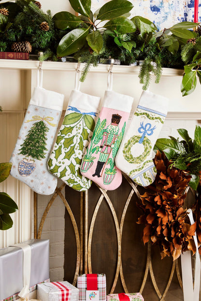 Festive mantle decorated with a Full Size Stockings, greenery, and holiday ornaments