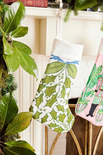 Full-size Christmas stocking featuring a vibrant greenery, holly, and decorative accents in festive shades of green and white