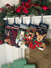 Festive mantle decorated with a Full Size Stockings, greenery, and holiday ornaments