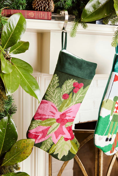 Full-size Christmas stocking featuring a pink bow with holly and pine branches on a green backdrop