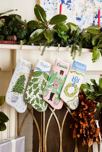 Festive mantle decorated with a Full Size Stockings, greenery, and holiday ornaments