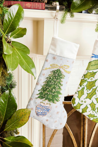 Full-size Christmas stocking featuring a vibrant, hand-stitched Christmas tree adorned with glittering ornaments on a soft light blue background