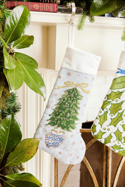 Full-size Christmas stocking featuring a vibrant, hand-stitched Christmas tree adorned with glittering ornaments on a soft light blue background