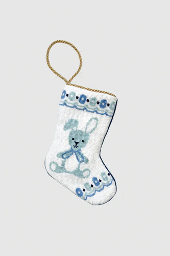 Needlepoint stocking with blue bunny and stitched border accents on white background