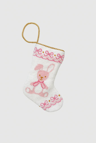 Needlepoint stocking with pink bunny and ribbon details on white background