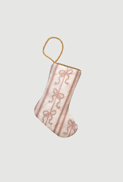 Hand-stitched needlepoint Bauble Stockings featuring pink ballet ribbons and soft swirl patterns on a white backdrop