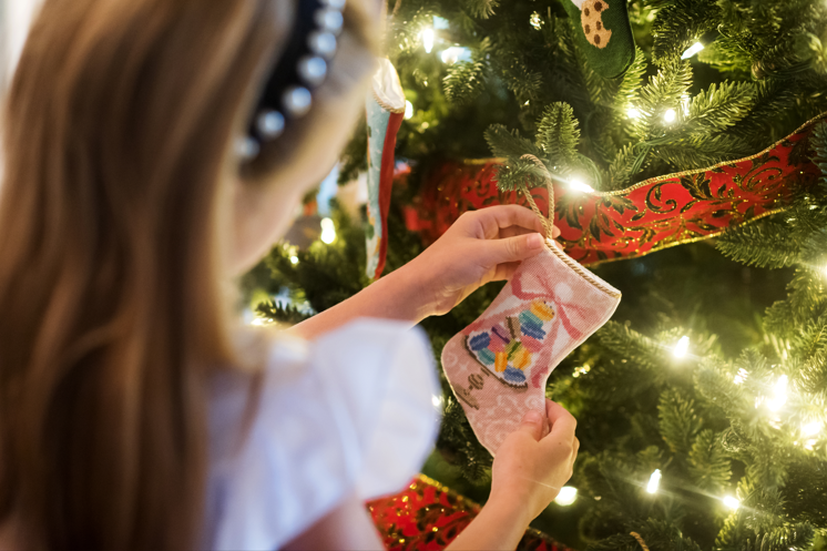 Christmas tree decorated with Bauble Stockings, shimmering ornaments, and twinkling lights
