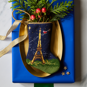 Bonne Nuit Santa in Paris Bauble Stockings displayed with festive decor and holiday greenery
