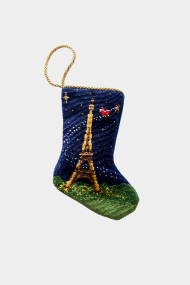 Hand-stitched needlepoint stocking featuring the Eiffel Tower with Santa flying over the Paris night sky on a navy background.