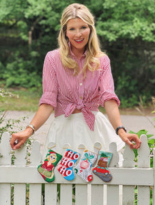 Bauble Stockings featuring stylish Mrs. Claus design displayed in greenery outdoor holiday setting
