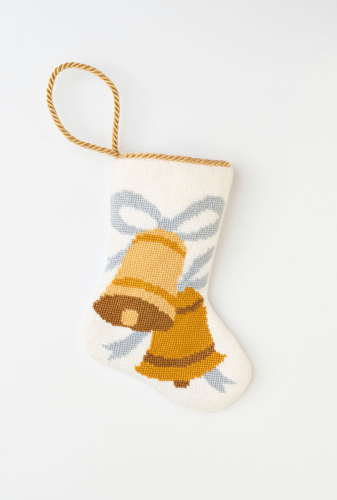 Needlepoint stocking with two golden bells with ribbon on a white background