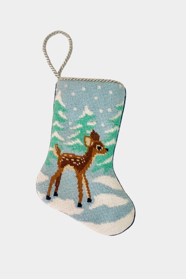 Hand-stitched needlepoint stocking featuring a fawn in a snowy landscape on a soft blue background