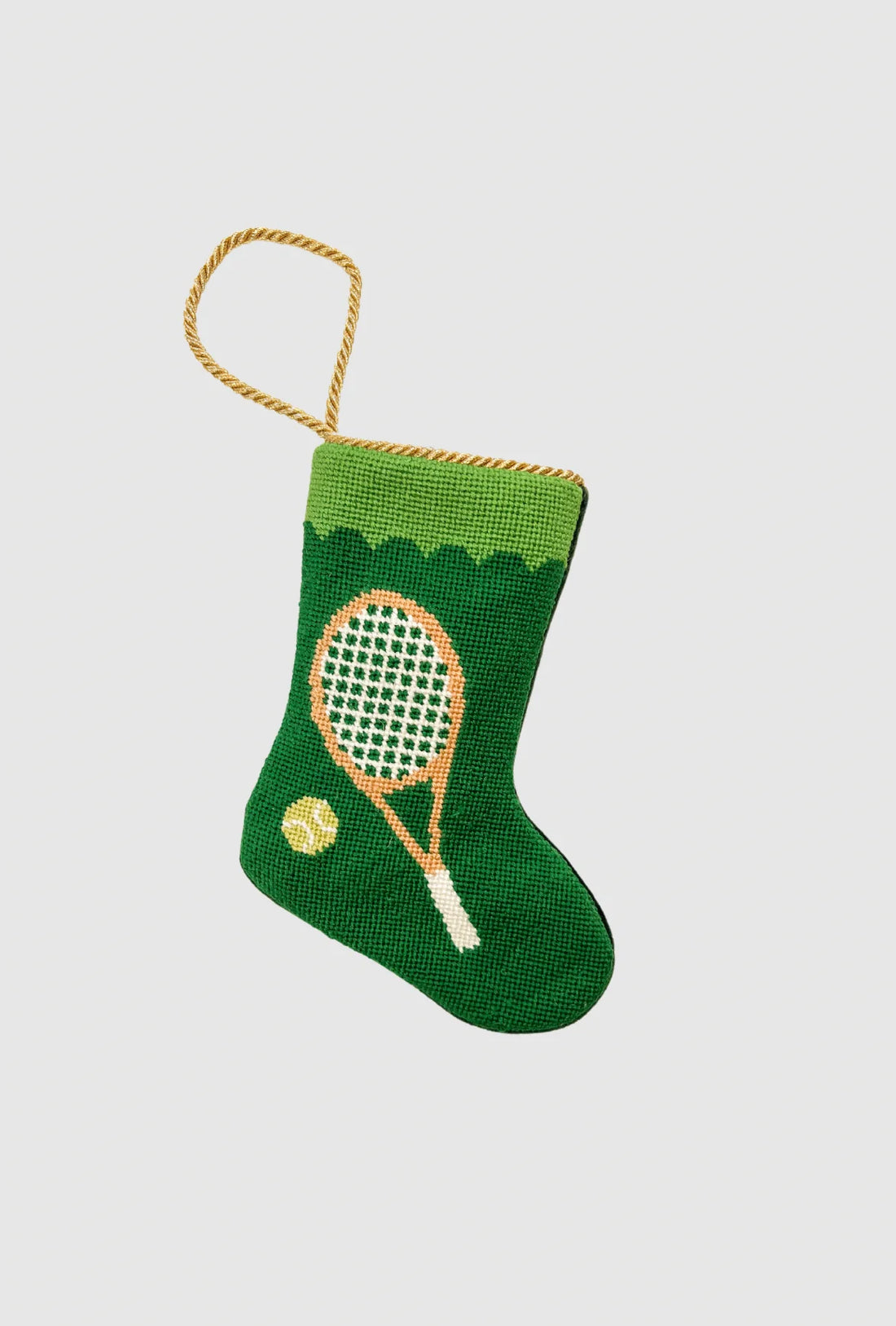 Needlepoint stocking featuring tennis racquet and tennis ball on green background