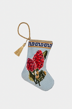 Needlepoint stocking featuring a vibrant red ginger floral with a Greek key border on a soft blue background, finished with a tassel