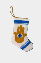 Hamsa Hand needlepoint stocking with gold hand and blue evil eye on white and blue background