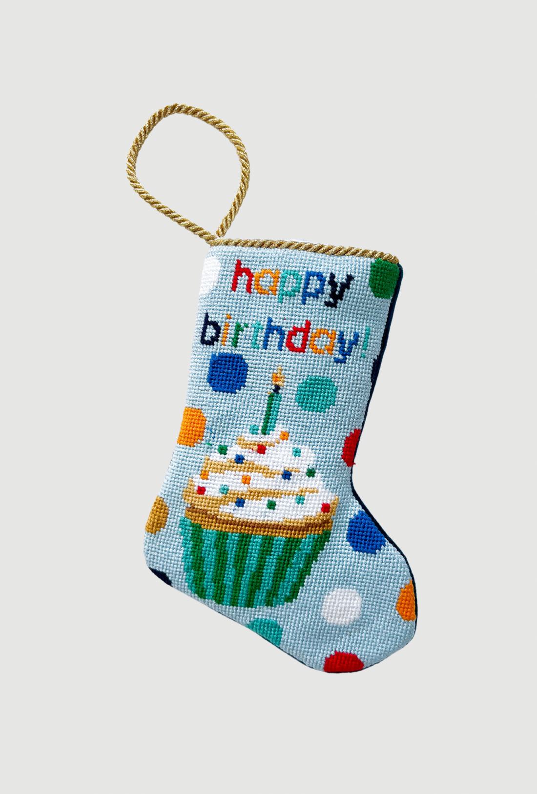 Needlepoint Bauble Stockings featuring a colorful cupcake and "Happy Birthday" lettering with polka dots on a blue background