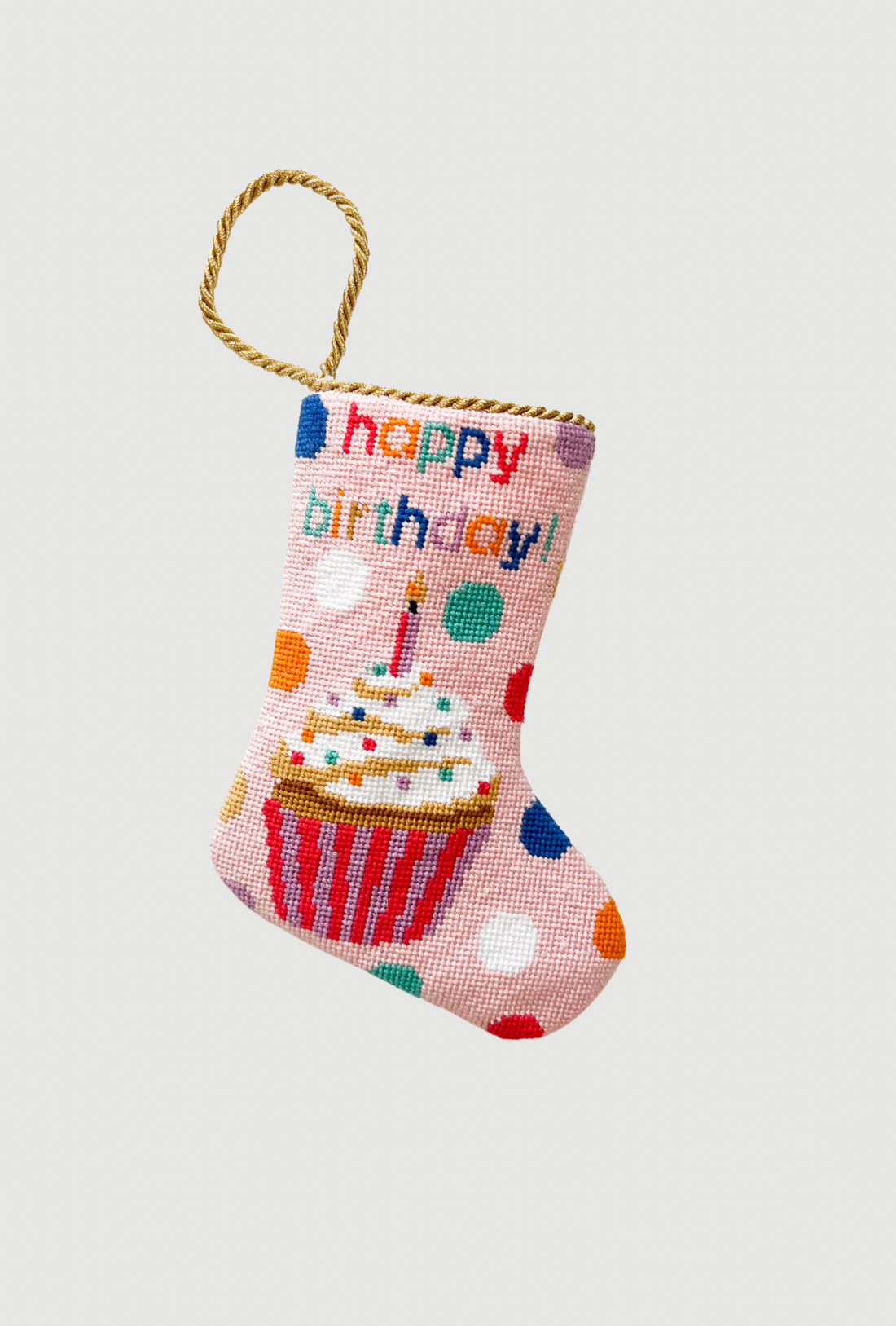 Hand-stitched Bauble Stockings featuring colorful "Happy Birthday" lettering and a cupcake with polka dots on a pink background