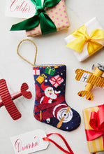 Bauble Stockings displayed with colorful ribbons and gift-wrapped presents, featuring airplanes in the design