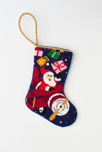 Hand-stitched High Flying Santa Bauble Stockings featuring Santa with gifts and flying in an airplane against a navy blue background