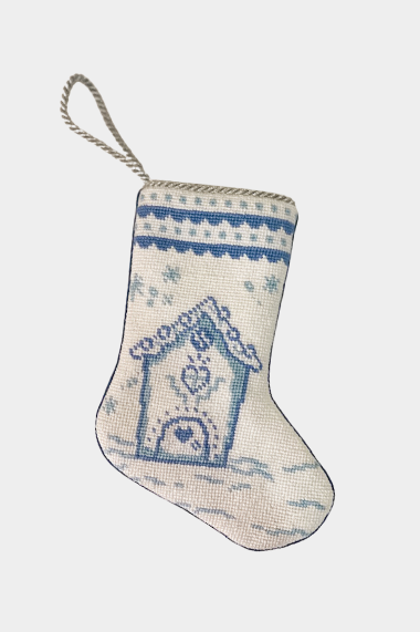 Needlepoint stocking featuring a blue gingerbread-style house with snowflakes and decorative border