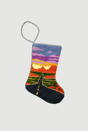 Needlepoint stocking featuring a winding Route 66 highway beneath a vivid sunset sky