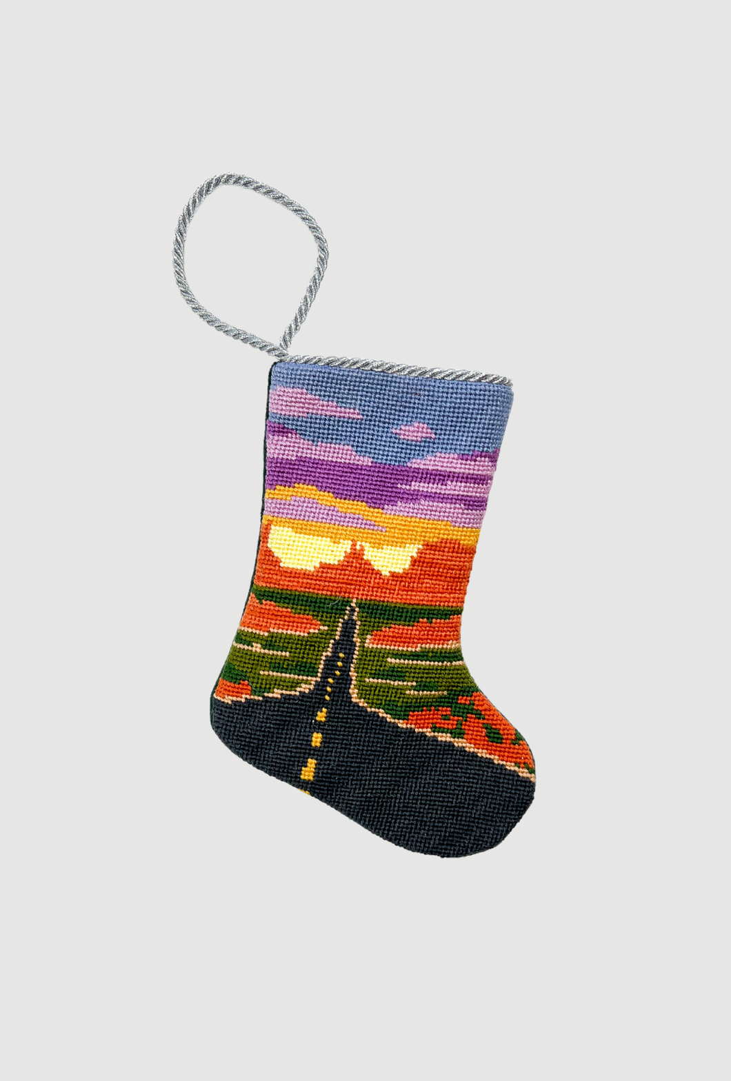 Needlepoint stocking featuring a winding Route 66 highway beneath a vivid sunset sky