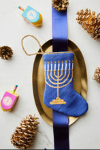 Light the Menorah Bauble Stockings displayed with Hanukkiah-themed decorations.