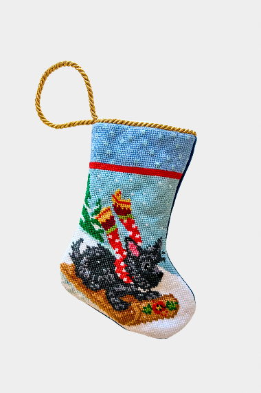 Hand-stitched Christmas stocking featuring Scottie the dog in red scarf riding a sled through a snowy landscape