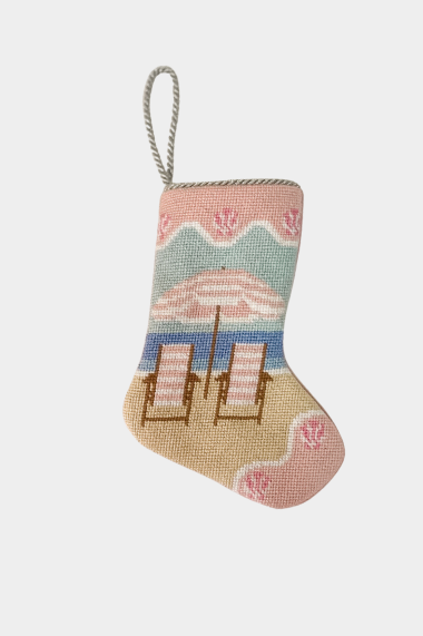 Needlepoint stocking featuring two beach chairs facing the ocean with pink and blue accents