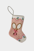 Needlepoint stocking featuring crossed tennis rackets with bow on pink background with scalloped floral trim
