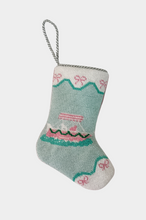 Needlepoint stocking featuring a pink yacht sailing on teal waves, bordered with pink bows