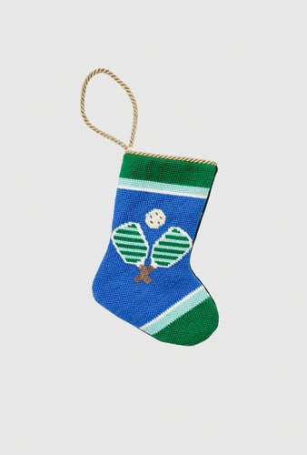Hand-stitched needlepoint stocking featuring pickleball paddles and ball on blue background
