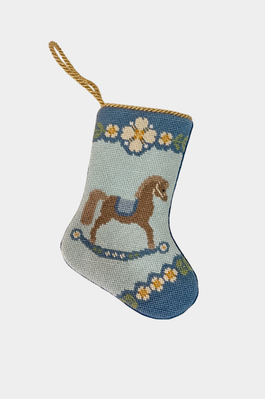 Hand-stitched stocking featuring a brown horse with a blue saddle and floral garland details on a soft blue background