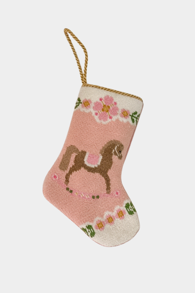 Hand-stitched stocking featuring a brown horse with a pink saddle and floral garland details on a pink background