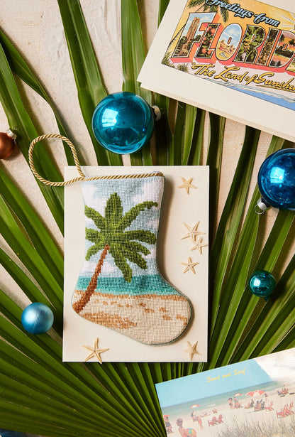 Bauble Stockings styled among tropical palm leaves and holiday ornaments for coastal decor