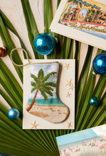 Bauble Stockings styled among tropical palm leaves and holiday ornaments for coastal decor