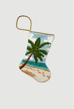Hand-stitched Bauble Stockings featuring palm tree, sandy beach, and blue ocean in the background