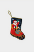 Hand-stitched Christmas stocking featuring Santa in a sleigh filled with gifts, set against a navy night sky with stars