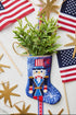 Hand-stitched Bauble Stockings displayed alongside American flag and holiday-themed decor