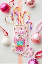 Sugary Sweet Nutcracker Bauble Stockings styled with colorful candy canes and festive backdrop
